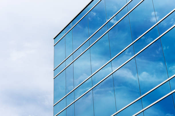 istock Exterior view of typical blue glass facade of generic modern office building. Sky reflection 1269406725