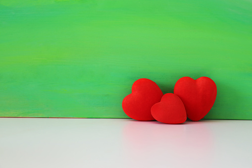 Heart shapes on green background