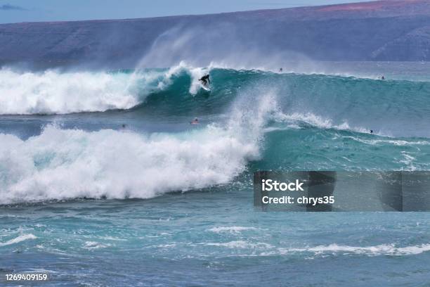 Lone Surfer On A Big Wave On Maui Stock Photo - Download Image Now - Surfing, Breaking Wave, Maui