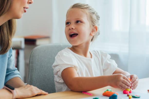 istock Kids and Crafts: Mother and Daughter Making Plasticine Figurines at Home 1269415668