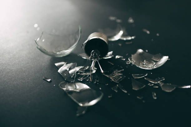 istock Exploded And Shattered Tungsten Light Bulb And Glass Pieces Around It 1269416442