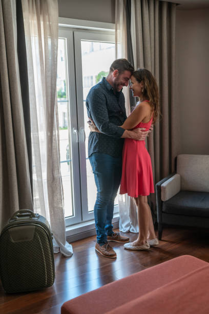 istock Couple embracing at hotel room 1269417375