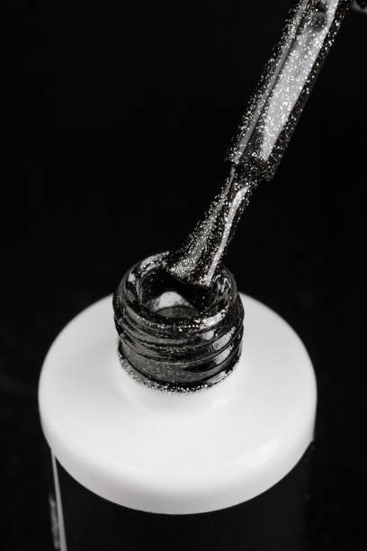 istock Black nail polish with shimmer on black background 1269423229