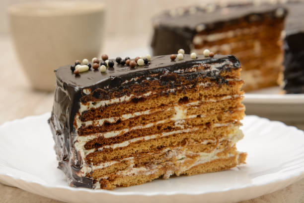 istock Puff cake with chocolate. Sliced piece on a plate. Wood background 1269423238