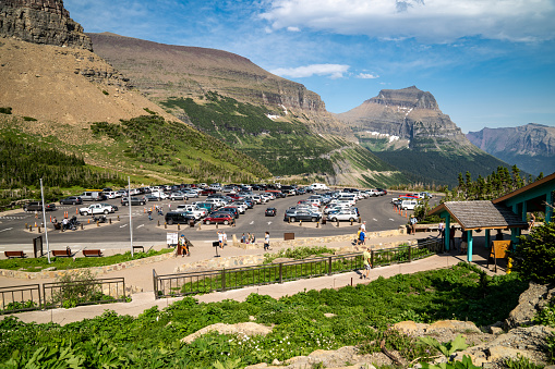Montana, USA - July 28, 2020: View of the crowds and parking lot cars at Logan Pass in Glacier National Park along Going to the Sun Road