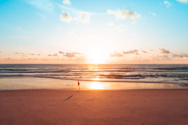 istock Beach with bokeh orange sunset theme color background. 1269427181