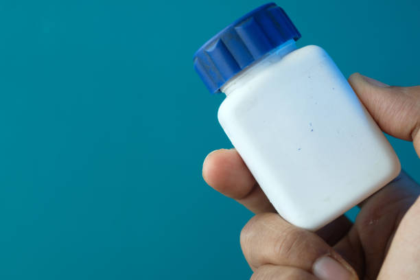 istock Close up of person hand holding pill container 1269429700