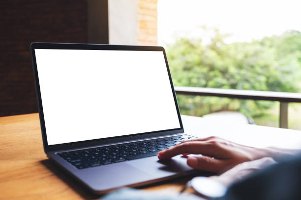 istock a woman using and touching on laptop computer touchpad with blank white desktop screen on wooden table 1269440138