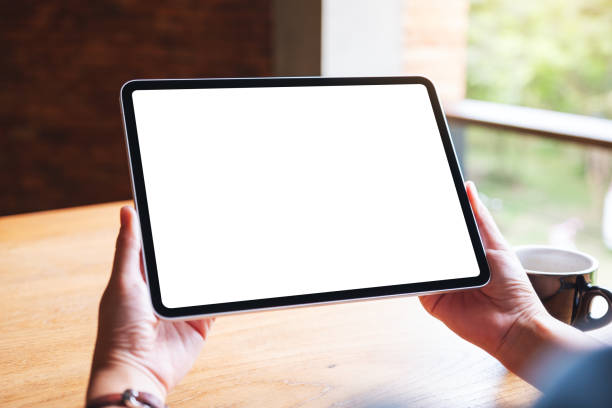 istock a woman holding digital tablet with blank white desktop screen in cafe 1269440182