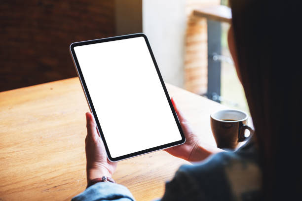 istock a woman holding digital tablet with blank white desktop screen in cafe 1269440695