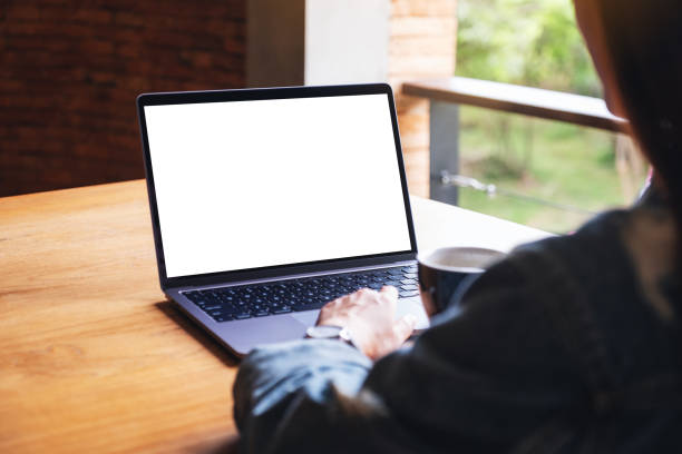istock a woman using and typing on laptop computer keyboard with blank white desktop screen on wooden table 1269440699
