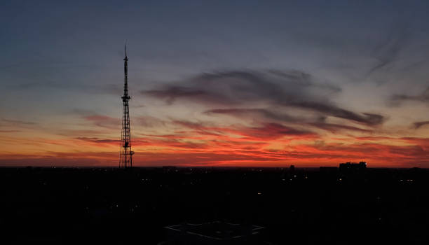 istock Orange sundown over cityscape with industrial tower silhouette 1269444811