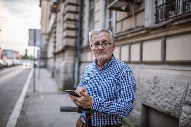 istock Senior man using mobile phone outdoors 1269445570