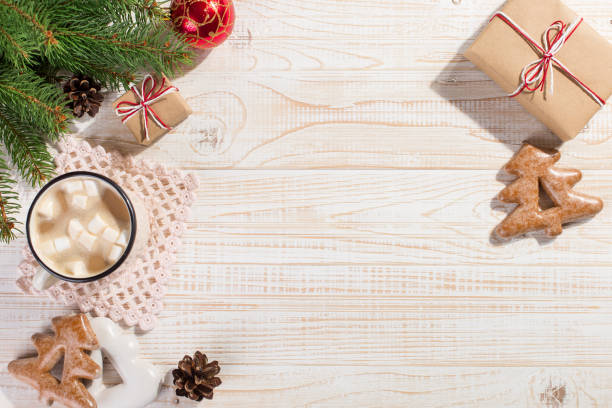 istock Hot Christmas drink with marshmallows in an iron mug and gingerbread cookies, on a white table. New Year, holiday background, copy space. 1269447540
