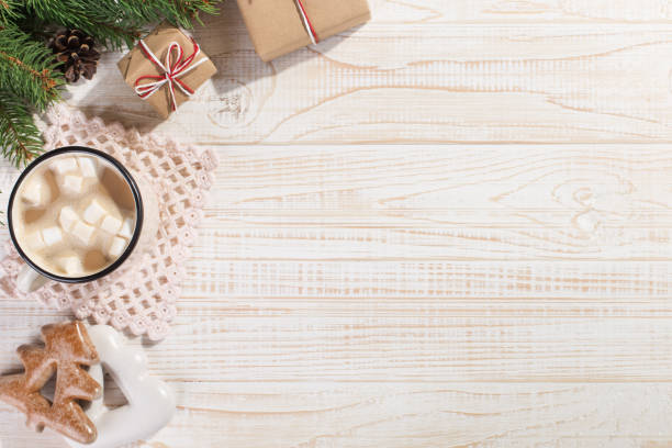 istock Hot Christmas drink with marshmallows in an iron mug and gingerbread cookies, on a white table. New Year, holiday background, copy space. 1269447549
