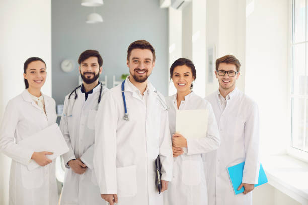 istock A group of confident practicing doctors in white coats are smiling against the backdrop of the clinic. 1269458225