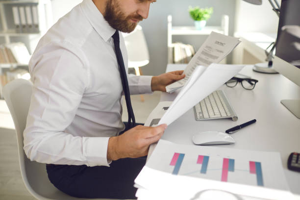 istock Office work is faceless. Businessman works at a table with a computer in the office. 1269458320