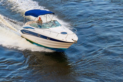 Kiev, Ukraine - June 27, 2020: White modern speedboat sailing on the Dnieper river in Kiev, Ukraine