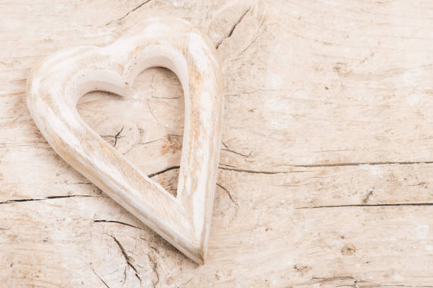 Wooden hart on a pile wooden background