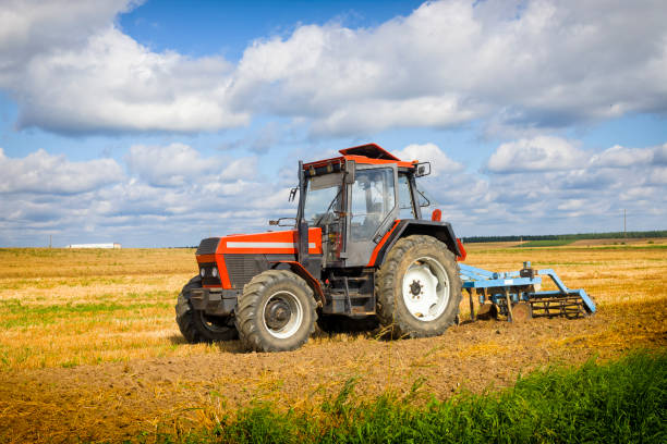 istock Tractor with plowing machine on the plantation 1269459454