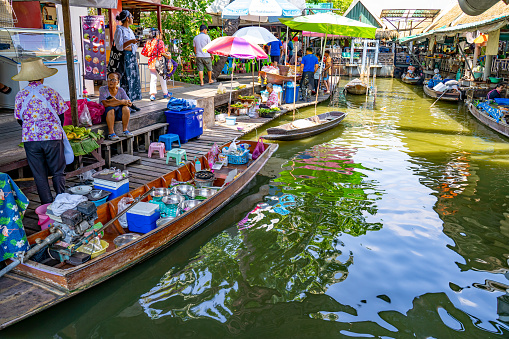 Famous Damnoen Saduak floating market in Thailand, Farmer goes to sell organic products, fruits, vegetables and Thai food, Ratchaburi province tourism concept. Thailand