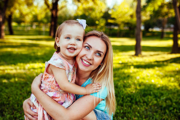 istock Happy mom and daughter smiling at nature 1269461373