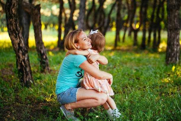 istock Happy mom and daughter smiling at nature 1269461396