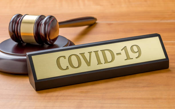 A gavel and a name plate with the engraving COVID-19 A gavel and a name plate with the engraving COVID-19 lawsuit photos stock pictures, royalty-free photos & images