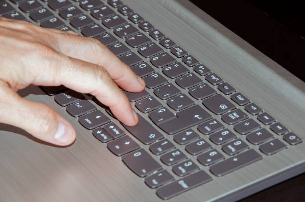 istock hand touching the keys of a laptop 1269465913