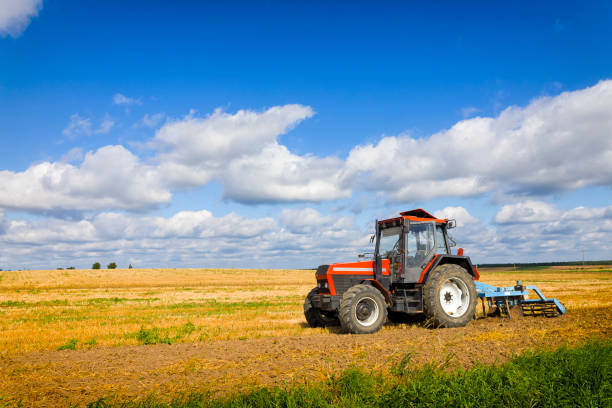 istock Tractor with plowing machine on the plantation 1269467254