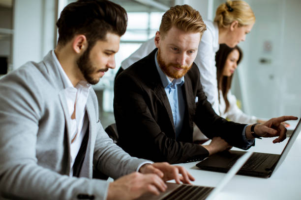 istock Young business people sharing their ideas in the office 1269469379