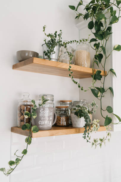 Open wooden shelves in the kitchen, pantry. View of the kitchen stock photo