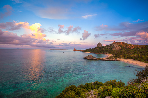 Early morning on stunning Izena island. The full moon can be seen low in the sky.