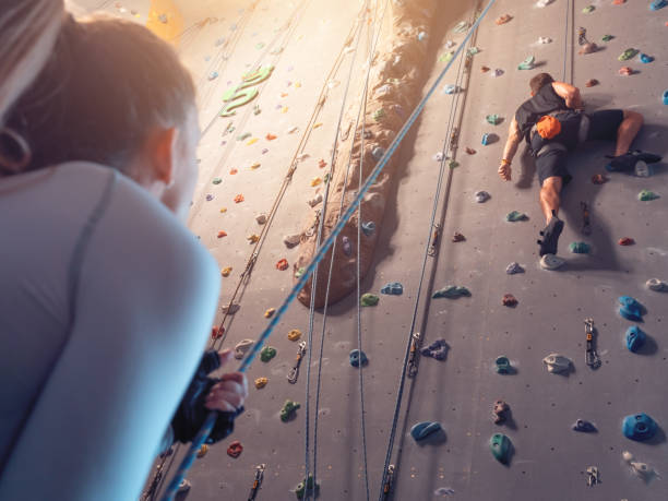 Couple mutual agreement. Support concept. Climbering in boulder gym. stock photo