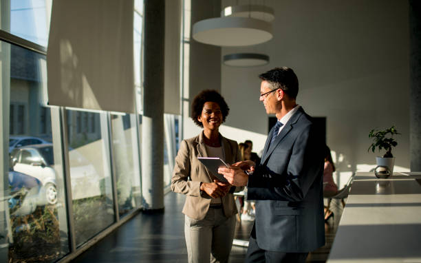 istock Multiethnic business people using digital tablet while standing in the office 1269475092