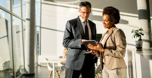 istock Multiethnic business people using digital tablet while standing in the office 1269475100
