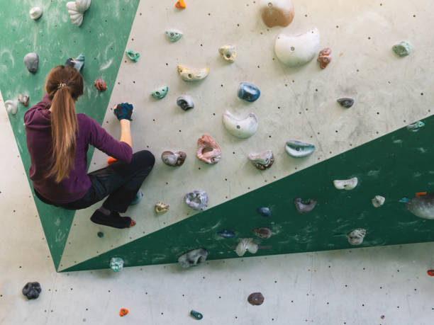 istock A woman climbing in boulder gym in the wall. 1269475162