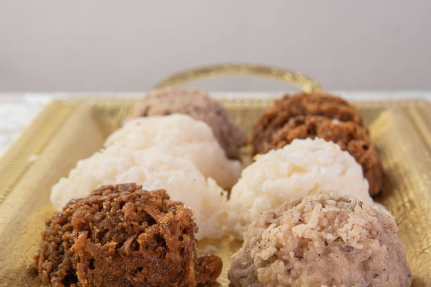 istock Brazilian cocada (coconut candy) placed on a golden tray on a table with white towel, selective focus. 1269475219