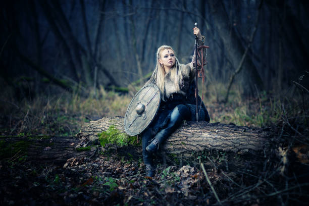 Beautiful Blonde Sword wielding Viking warrior female. Movie scene stock photo