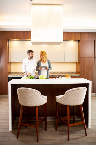 istock Couple cooking in the modern kitchen and using  digital tablet 1269475982