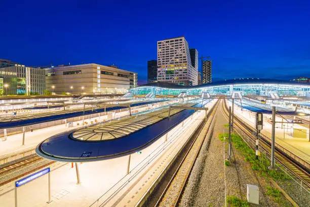 Photo of Utrecht central railway station at dusk. Modern contemporary architecture