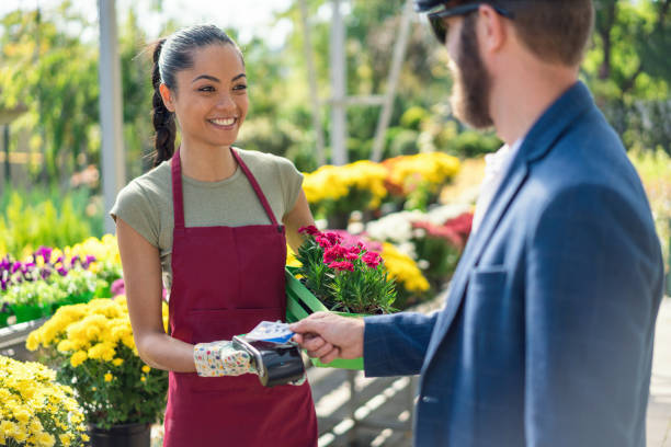 istock Man paying on POS terminal at the garden center 1269476530
