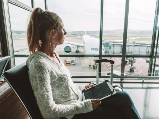 Woman using digital tablet in airport