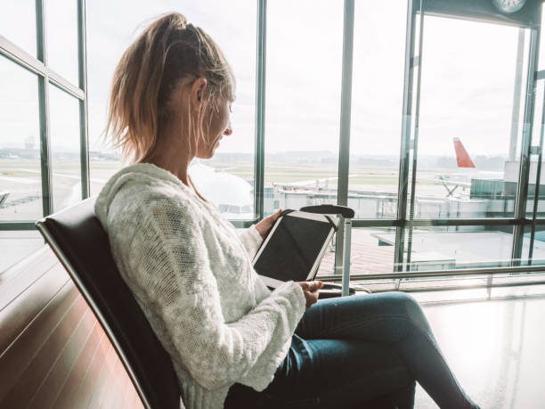 istock Woman using digital tablet in airport 1269478782