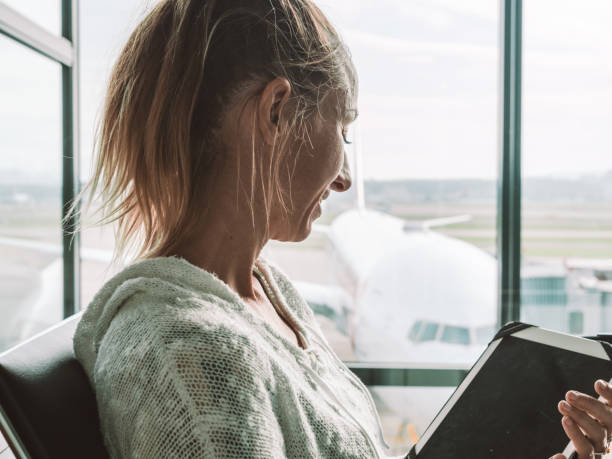 istock Woman using digital tablet in airport 1269478825