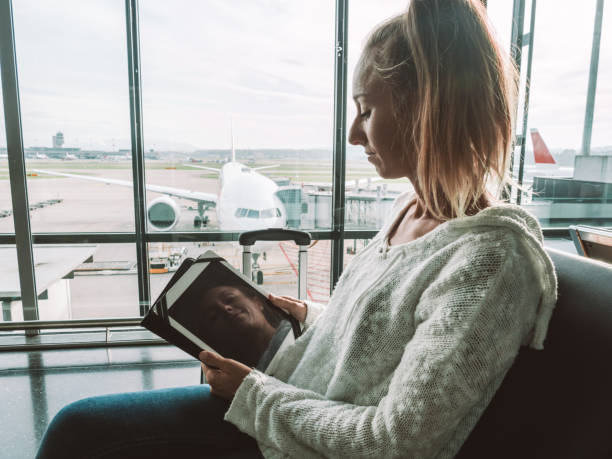istock Woman using digital tablet in airport 1269479430