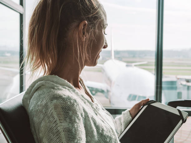 istock Woman using digital tablet in airport 1269479449