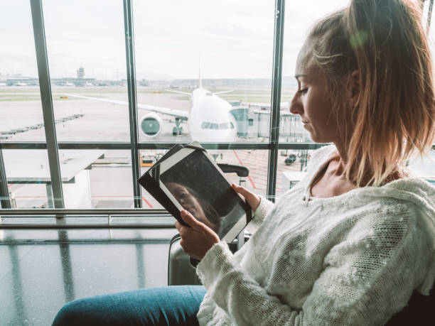 istock Woman using digital tablet in airport 1269479498