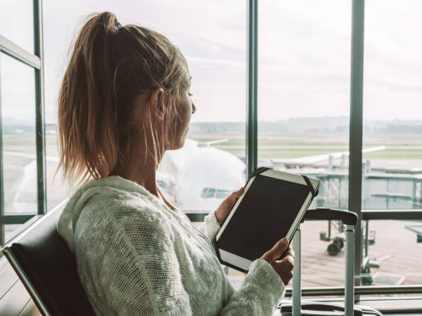 istock Woman using digital tablet in airport 1269479511