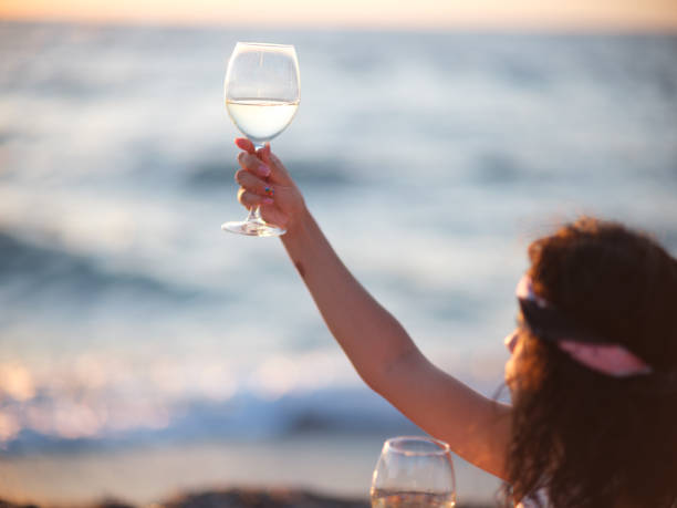 istock Young woman eating grapes 1269479542